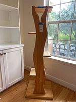 Full view of cat tree showing base, column and perches next to window