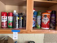 Cabinet shelf with ACE, Rust-Oleum, five Montana Black cans, Sprayway glass cleaner, Febreze air freshener, disinfecting wipes, Cristal tire finish