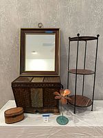 Group shot showing mirror, trunk, plant stand, lidded box, metal flower sculpture