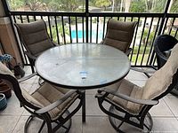 Entire dining set showing table and four chairs on patio