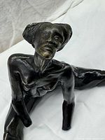 Close front angle showing facial detail, hair texture, arm position