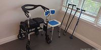 Group shot of walker, shower chair, and four quad canes