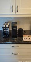 Coffee maker, pod holder with pods, manual on countertop