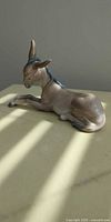 Left side view of Lladro reclining donkey figurine