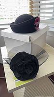 Both hats, fascinator in foreground, Georgetti felt hat on box