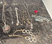 Full layout of all necklaces, bracelets, pendants on countertop