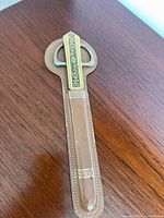 Leather stitched sheath with gold-tone detail