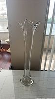 Full view of tall clear crystal vase on table
