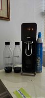 Front view of SodaStream machine, two bottles, CO₂ cylinder
