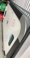 Air hockey tabletop showing play surface, side rails, and manual scorers