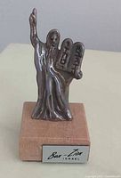 Front view of silver Moses figure on wood base showing tablets and Bar-Ilan Israel plate