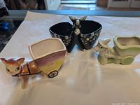 All three ceramic donkey planters grouped