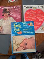 All three magazines laid out showing covers
