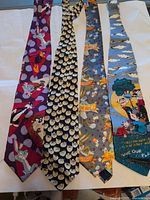 All four cartoon novelty ties laid flat