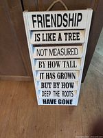 Full view of wooden friendship quote sign