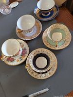 All five teacup and saucer sets laid out