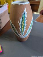 Full side view of vase showing leaf motif and overall shape