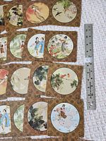 Assortment of coaster fronts and backs with ruler for scale