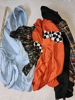 All four jackets laid out with yardstick for scale