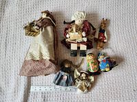 Group shot showing all seven dolls and scale ruler