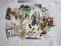 Overview of entire lot showing bags and jars of buttons with ruler for scale