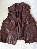 Front view of burgundy faux leather vest