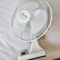 Front view showing blades, cage, logo, and base controls