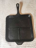 Overall view of square Lodge cast iron skillet showing three compartments