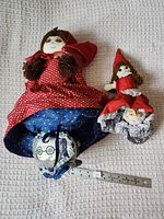 Both reversible dolls displayed side by side with ruler for scale, showing Red and Grandma sides
