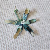 All six miniature shoes arranged star-style showing tops and colours