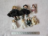 Front view of all dolls with ruler for scale