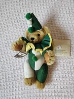 Full view of teddy bear in clown outfit showing overall appearance and attached tags