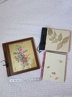 Front view of three blank paper pads with ruler for scale