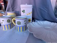 overall view of mugs, canisters and flower plate