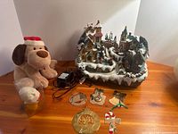 all items grouped: village, plush dog, ornaments, adapter