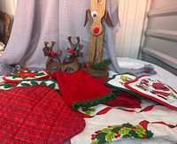 Full lot showing reindeer, crochet trivets, potholders, towel, runner