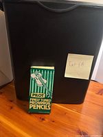 Black paper shredder with Pilot pencil box in front