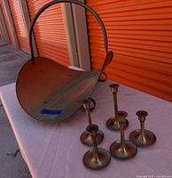 Full set: log holder and five candlesticks on table