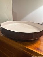 Full view of brown exterior and cream interior of pan