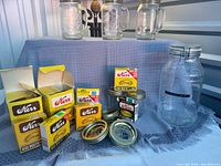 All items overview: Kerr lid boxes, loose lids, four handled jars, Biscuit Mix jar