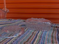 Oval candy dish with lid beside round trinket dish