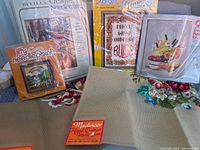 Group shot of all five needlework kits and canvas