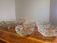 Large pressed glass serving bowl with four small bowls