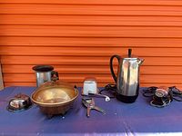 All six small appliances arranged on table against orange background