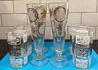 Front view of all eight glasses showing designs and count