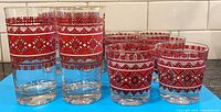 Full set showing 2 tall and 6 small glasses with Ukrainian pattern