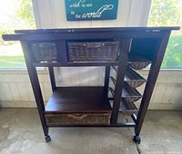 Front view of wood cart showing drawers, shelf and wine rack