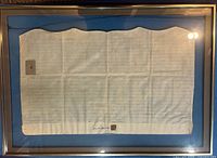 Front view of framed 1774 indenture showing handwriting and wax seal
