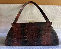 Front view of Danier crocodile-embossed leather purse