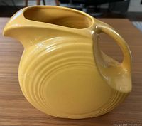 Left side view showing disc shape and yellow glaze